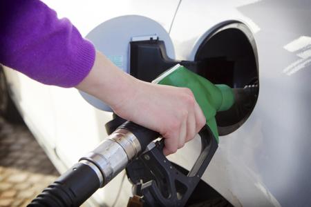 Woman filling petrol in car