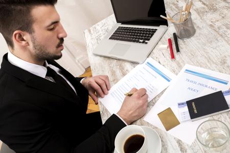 Man filling travel insurance form