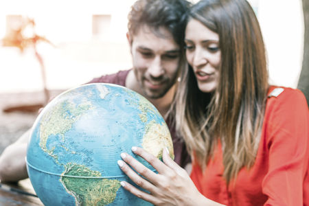 Smiling couple with globe