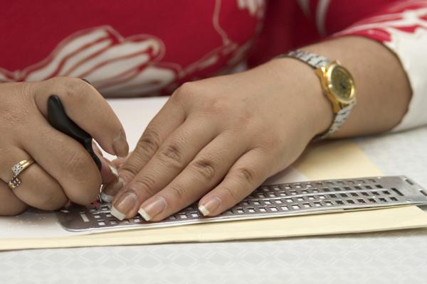 woman writing braille
