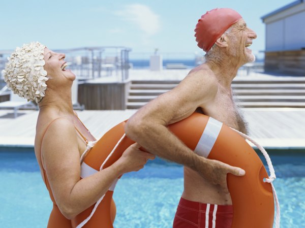 Senior couple at poolside laughing