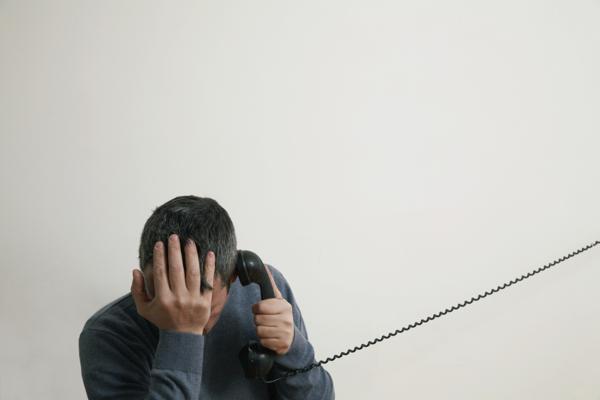 Depressed man on telephone