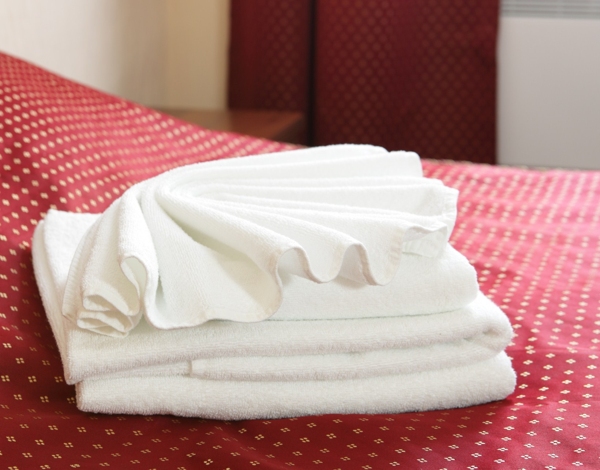 Towels on the bed in hotel