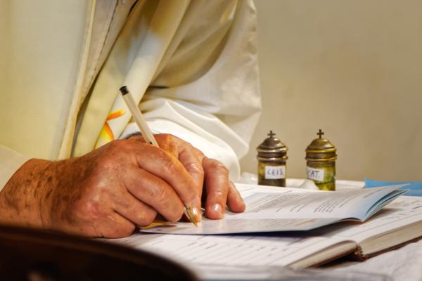 priest signing book