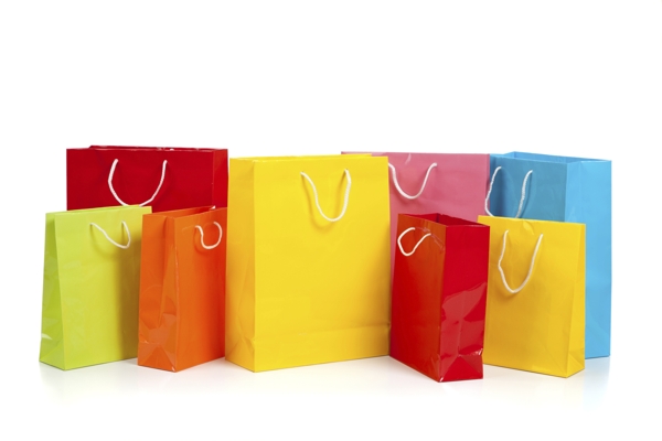 Assorted colored shopping bags on white