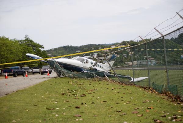 Plane crashes through fence