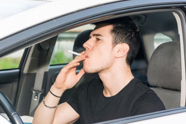 Man smoking in car