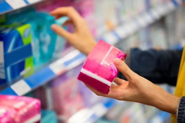 Woman buying tampon