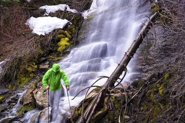 Hiking and exploring mountain waterfall
