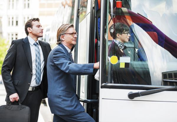 Business people entering the bus