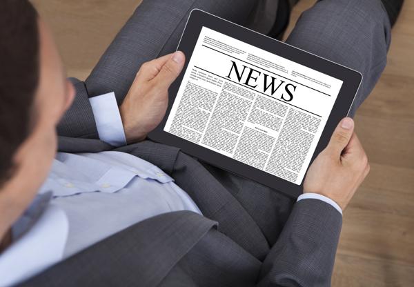 Businessman reading news on tablet