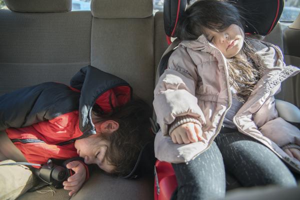 children sleeping in car