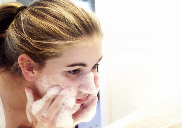 Girl washing her face