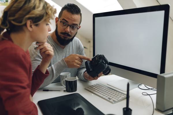 Photographers working in their office