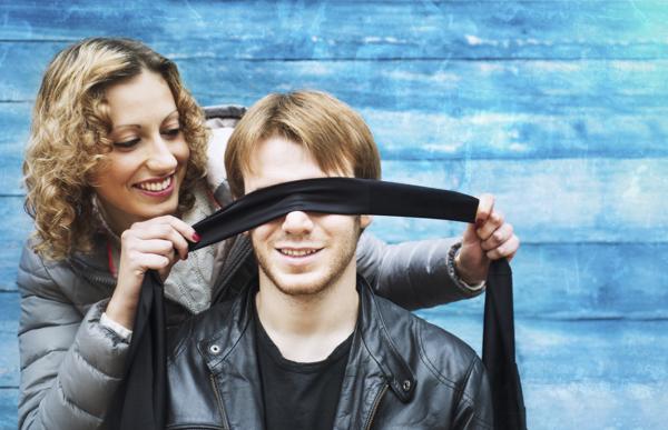girl blindfolding boy