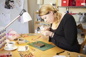 mature woman making jewelry
